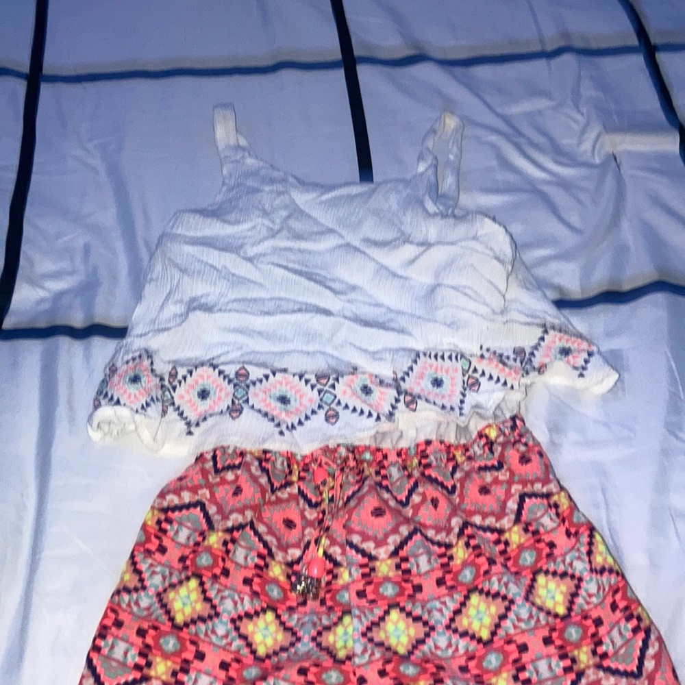 White top with colorful shorts romper